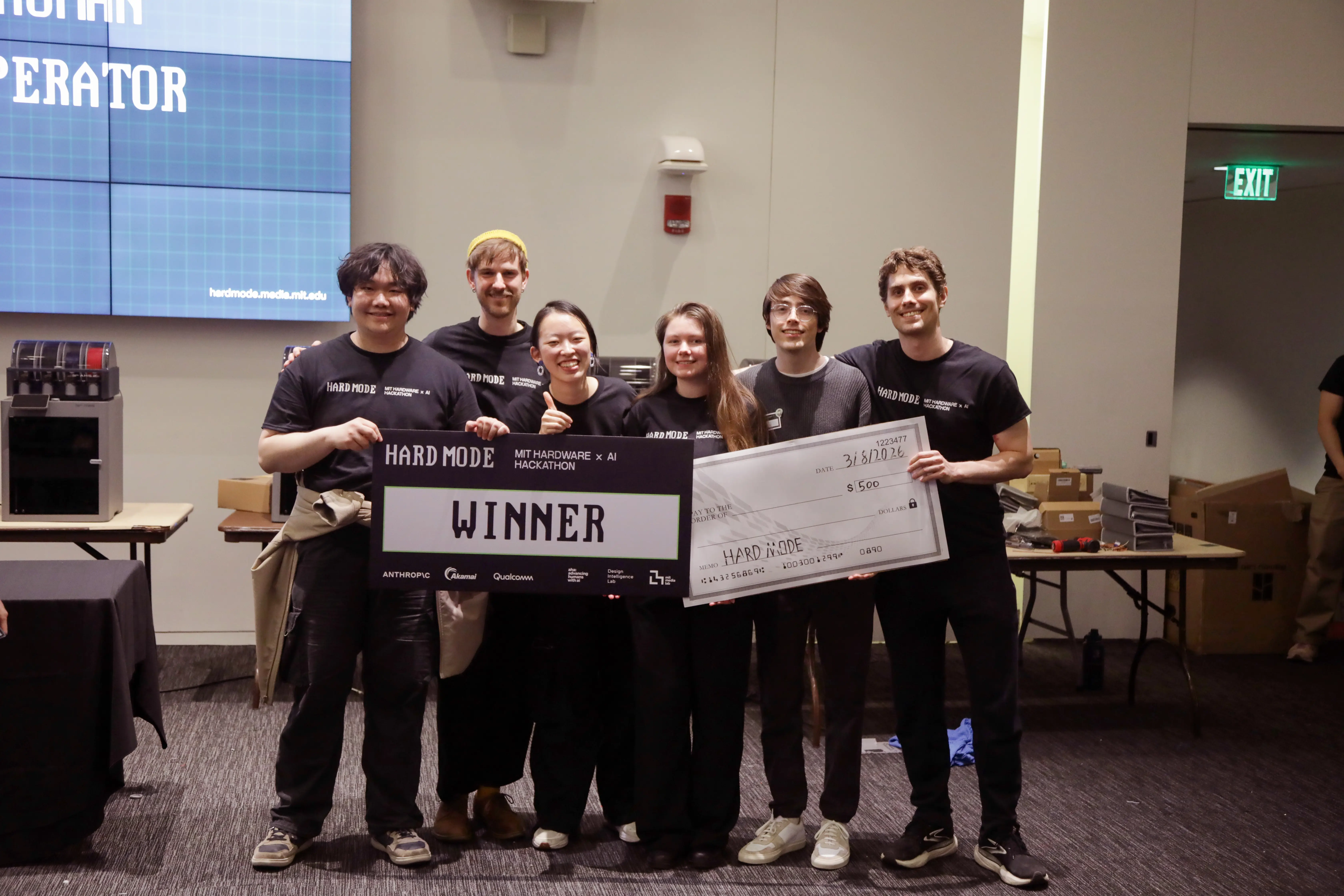 Winners of MIT Hard Mode hackathon holding a giant check.